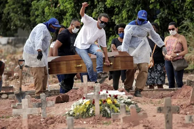 A woman victim of COVID-19 is buried in a cemetery in Rio de Janeiro, Brazil, 06 April 2021. Brazil registered 4,195 deaths associated with COVID-19 in the last 24 hours, a new daily maximum, and accumulated 336,947 deaths since the start of the pandemic just over a year ago, official sources reported on 06 April. (Photo by Antonio Lacerda/EPA/EFE)