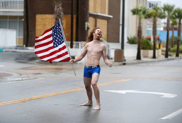 Lane Pittman of Jacksonville, Florida, stands in the wind and rain along Ocean Boulevard during Hurricane Florence in Myrtle Beach, South Carolina, U.S. September 14, 2018. (Photo by Randall Hill/Reuters)