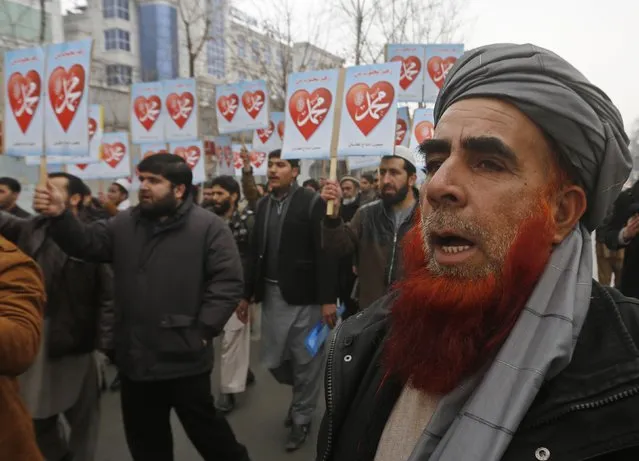 People chant slogans during a demonstration against the satirical French weekly Charlie Hebdo's cartoons of Prophet Mohammad, in front of the French embassy in Kabul January 22, 2015. French satirical magazine Charlie Hebdo published a picture of Mohammad weeping on its cover last week after gunmen stormed its offices in Paris, killing 12 people. The signs read, “Mohammad”. (Photo by Omar Sobhani/Reuters)