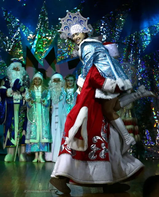 People dressed as Father Frost, the equivalent of Santa Claus, and Snow Maiden take part in the contest “Yolka-fest-2016” (Fir-festival-2016) in Minsk, Belarus December 9, 2016. (Photo by Vasily Fedosenko/Reuters)