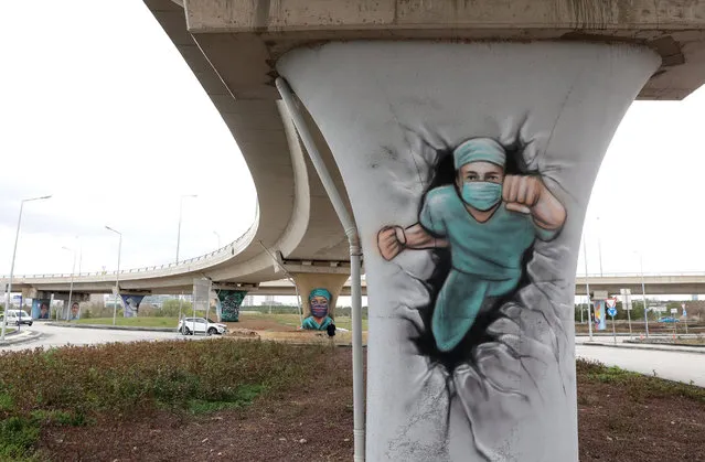 Ankara's Metropolitan Municipality have used graffiti to symbolise the work and dedication by healthcare workers during the Covid-19 pandemic in the City Hospital region of Ankara on April 19, 2021. (Photo by Adem Altan/AFP Photo)