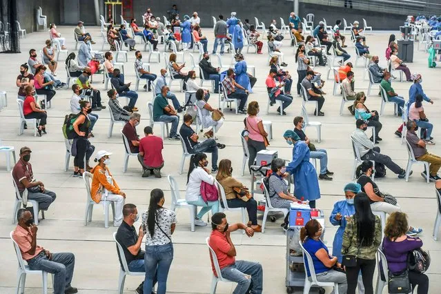 People over 50 years of age are inoculated against COVID-19 at a vaccination centre mounted at a volleyball arena in Medellin, Colombia, on June 1, 2021, amid the ongoing novel coronavirus pandemic. (Photo by Joaquin Sarmiento/AFP Photo)