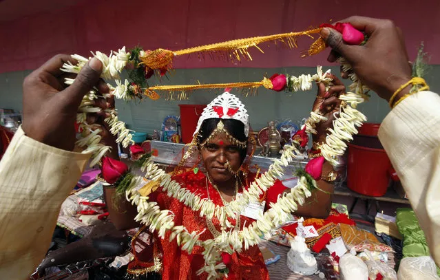 A couple hold garlands as they say their wedding vows during a mass marriage ceremony at Bahirkhand village, north of Kolkata, February 6, 2011. (Photo by Rupak De Chowdhuri/Reuters)