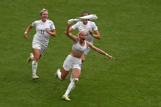England's Chloe Kelly, centre, celebrates after scoring her side's second goal during the Women's Euro 2022 final soccer match between England and Germany at Wembley stadium in London, Sunday, July 31, 2022. (Photo by Rui Vieira/AP Photo)