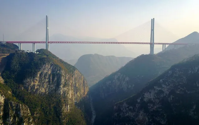 This picture taken on December 28, 2016 shows the Beipanjiang Bridge, near Bijie in southwest China's Guizhou province. The world's highest bridge has opened to traffic in China, connecting two southwestern provinces and reducing travel time by three quarters, local authorities said on December 30. (Photo by AFP Photo/Stringer)