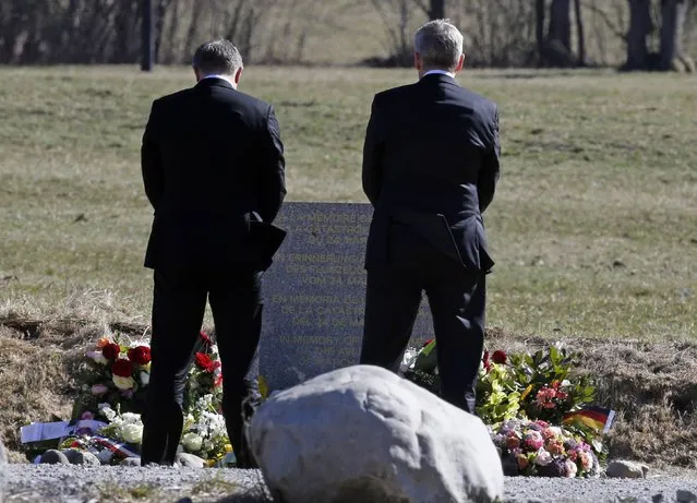 Lufthansa Chief Executive Carsten Spohr (L) and Germanwings Managing Director Thomas Winkelmann carry flowers as they pay their respects at the memorial for the victims of the air disaster in the village of Le Vernet, near the crash site of the Germanwings Airbus A320 in French Alps April 1, 2015. (Photo by Jean-Paul Pelissier/Reuters)