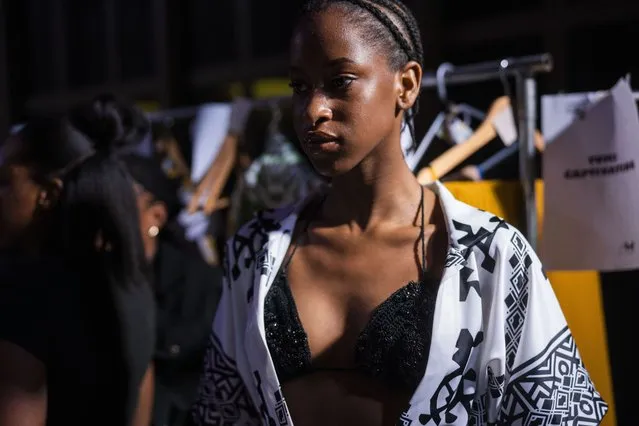 A model dresses up backstage for Niger's designer Alia Bare's show during Johannesburg Fashion Week 2023 in Johannesburg, South Africa, Thursday, November 9, 2023. (Photo by Jerome Delay/AP Photo)