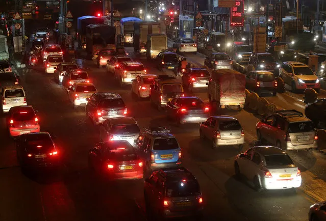 Vehicles are pictured at a toll post in Mumbai, India on August 1, 2021. (Photo by Francis Mascarenhas/Reuters)