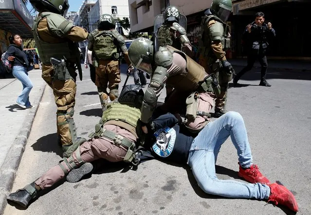 A demonstrator is detained during a rally on the third anniversary of the protests and riots that rocked the country in 2019, in Valparaiso, Chile on October 18, 2022. (Photo by Rodrigo Garrido/Reuters)