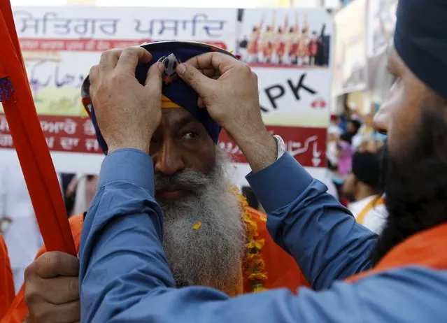 Sikh devotees prepare as they participate in the Baisakhi festival at Panja Sahib shrine in Hassan Abdel April 13, 2015. (Photo by Caren Firouz/Reuters)