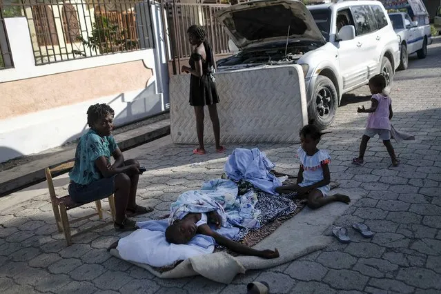 Residents stay outside their homes amid the fear of aftershocks in Saint-Louis-du-Sud, Haiti, early Monday, August 16, 2021, two days after a 7.2-magnitude earthquake struck the southwestern part of the country. (Photo by Matias Delacroix/AP Photo)