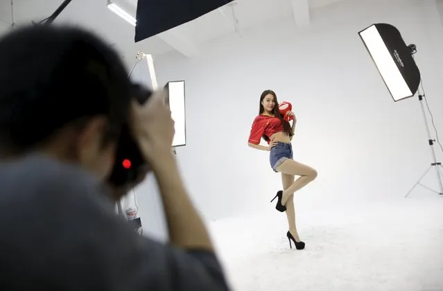 Online hostess Xianggong poses while taking part in a football themed photoshoot at a photography studio in Beijing March 4, 2015. (Photo by Jason Lee/Reuters)