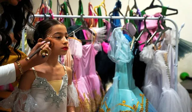 An Iraqi ballerina student of the Baghdad Ballet Academy prepares before performing in a show titled “The Sleeping Beauty” at Al-Rashid National Theater, in Baghdad, Iraq on September 30, 2023. (Photo by Saba Kareem/Reuters)