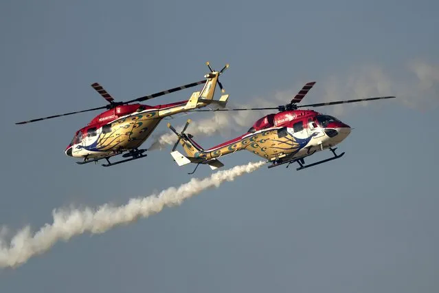 Sarang helicopter display team from India, perform during second day of the Dubai Air Show, United Arab Emirates, Tuesday, November 14, 2023. (Photo by Kamran Jebreili/AP Photo)