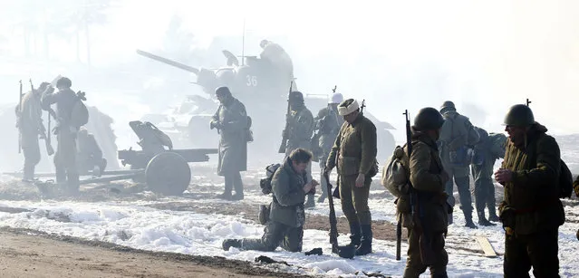 Military enthusiasts take part in a re-enactment of the World War II battle of Stalingrad at the “Stalin Line” memorial, near the village of Goroshki, Belarus, February 27, 2016. (Photo by Vasily Fedosenko/Reuters)