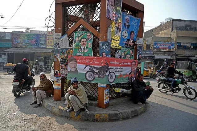 Motorcyclists ride past election campaign posters and banners ahead of the upcoming general elections in Rawalpindi on January 9, 2024. Pakistan will vote in elections on February 8, with rights groups warning the ballot will lack credibility with popular opposition leader Imran Khan jailed and barred from contesting. (Photo by Aamir Qureshi/AFP Photo)