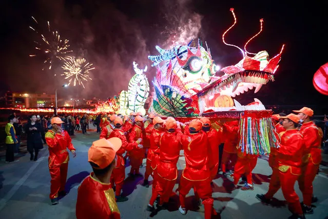 People perform with a long dragon lantern as they celebrate the Chinese Lunar New Year, in Longyan, Fujian province, February 3, 2017. (Photo by Reuters/Stringer)