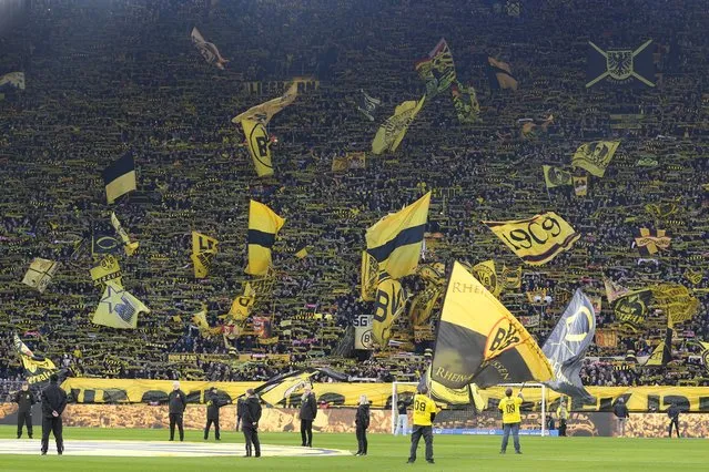 Dortmund supporters wave flags before the German Bundesliga soccer match between Borussia Dortmund and TSG Hoffenheim in Dortmund, Germany, Sunday, February 25, 2024. (Photo by Martin Meissner/AP Photo)
