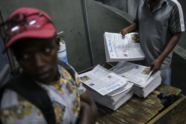 A worker organizes newspapers at Le Nouvelliste newspaper in Port-au-Prince, Haiti, Thursday, November 11, 2021. The U.S. government is urging U.S. citizens to leave Haiti given the country's deepening insecurity and a severe lack of fuel, which has limited this newspaper to operating only three days a week, and the paper reports it has had truck drivers kidnapped and fuel trucks hijacked. (Photo by Matias Delacroix/AP Photo)