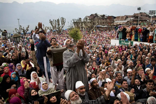 Kashmiri Muslim devotees pray as a head priest displays a relic, believed to be a hair from the beard of the Prophet Mohammad, during special prayers on the death anniversary of Abu Bakr Siddiq, the first Caliph of Islam, at Hazratbal Shrine on the outskirts of Srinagar, Indian controlled Kashmir, Friday, April 1, 2016. (Photo by Dar Yasin/AP Photo)