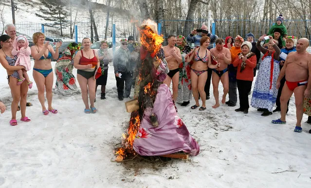 Members of the “Cryophile” winter swimmers club burn an effigy of Lady Maslenitsa during celebrations of Maslenitsa, or Pancake Week, a pagan holiday marking the end of winter, in the Siberian city of Krasnoyarsk, Russia, February 26, 2017. (Photo by Ilya Naymushin/Reuters)