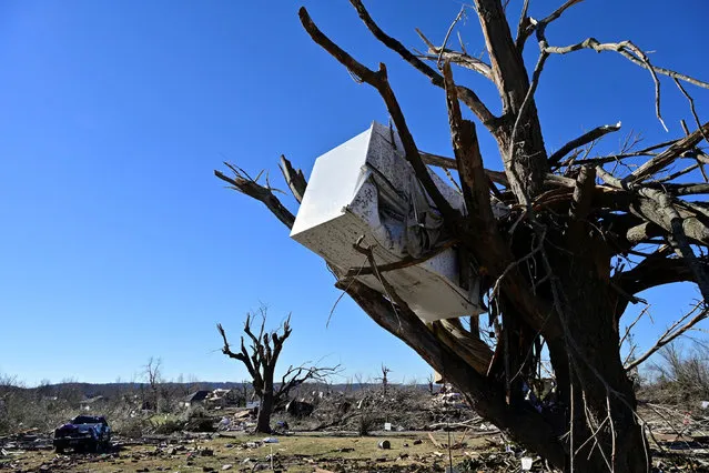 A refrigerator is stuck in a tree after tornadoes ripped through several U.S. states, in downtown Dawson Springs, Kentucky, U.S., December 13, 2021. (Photo by Jon Cherry/Reuters)