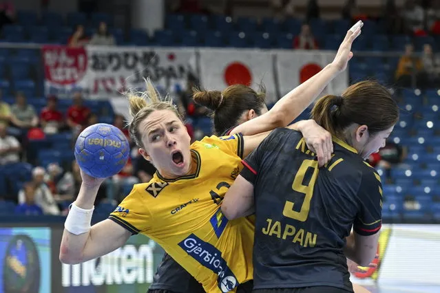 Jenny Karlsson, left, of Sweden is challenged by Chikako Kasai of Japan for the ball at the goal during the Olympic qualification handball match between Sweden and Japan in Debrecen, Hungary, Thursday, April 11, 2024. (Photo by Tibor Illyes/MTI via AP Photo)