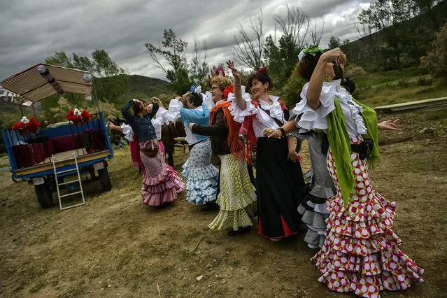 Devotees of the Rocio Virgin dance while taking part in the “Romeria de El Rocio” in the countryside outside Fitero, northern Spain, Saturday, May 25, 2019. (Photo by Alvaro Barrientos/AP Photo)