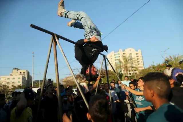 A Palestinian performs stunts during a cultural carnival organized by Gaza Municipality in Gaza City April 1, 2016. (Photo by Mohammed Salem/Reuters)