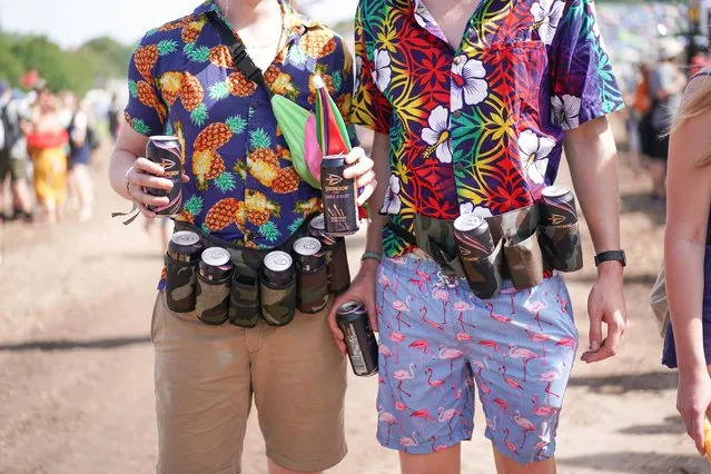 Two festival goers with a belt carrying cans of cider during Glastonbury Festival in Somerset, Britain on June 28, 2019. (Photo by Henry Nicholls/Reuters)