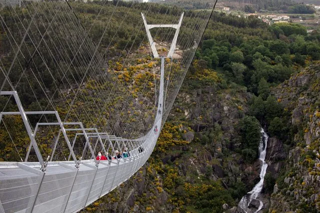 People walk on the world's longest pedestrian suspension bridge “516 Arouca”, now open for local residents in Arouca, Portugal, April 29, 2021. (Photo by Violeta Santos Moura/Reuters)