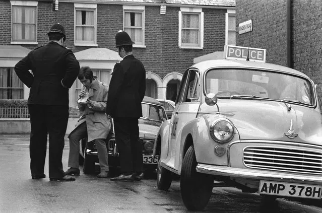 Two police officers administer a Breathalyser test to a driver on Finden Road in Newham, in the East End of London, 1960s. (Photo by Steve Lewis/Getty Images)