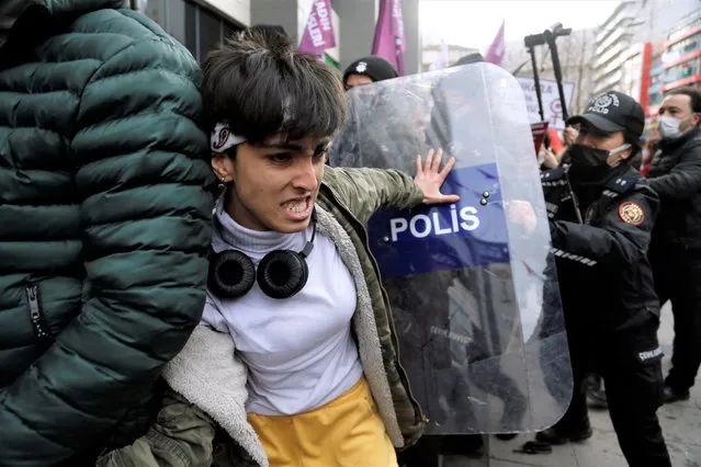 A demonstrator scuffles with riot police during a rally ahead of International Women's Day, in Ankara, Turkey on March 6, 2022. (Photo by Cagla Gurdogan/Reuters)