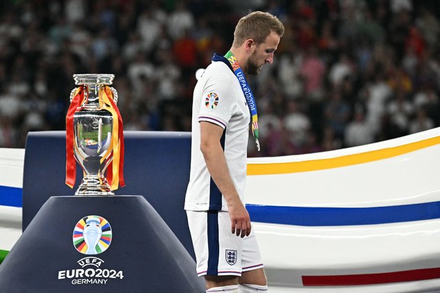 England's forward #09 Harry Kane receives a silver medal and walks past the trophy at the end of the UEFA Euro 2024 final football match between Spain and England at the Olympiastadion in Berlin on July 14, 2024. (Photo by Javier Soriano/AFP Photo)