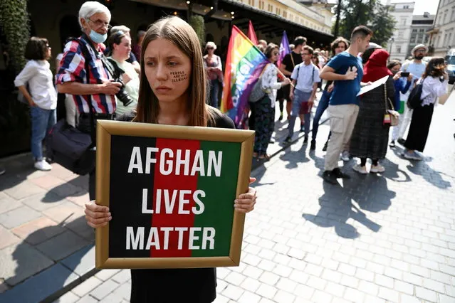 A participant holds a placard during a demonstration in solidarity with people of Afghanistan, in Krakow, Poland on August 22, 2021. (Photo by Jakub Porzycki/Agencja Gazeta/via Reuters)