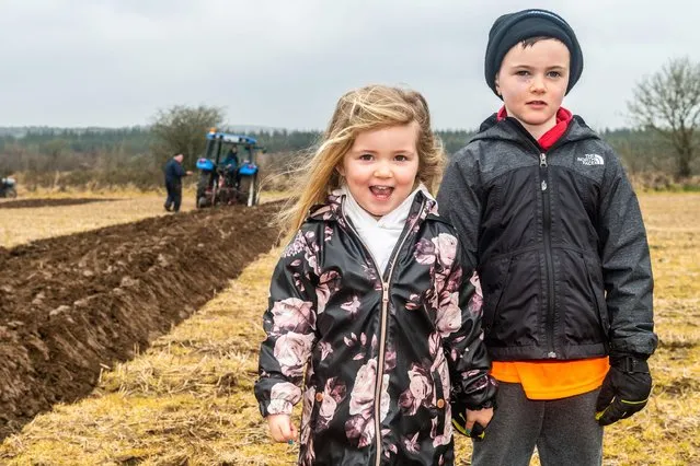 A ploughing match took place on the lands of John and Declan Buttimer, Rossmore in West Cork, Ireland on March 20, 2022. A large number of competitors took part in what is the penultimate ploughing match of the season with the Kilbrittain match next weekend. Enjoying the ploughing match were Olivia and Daniel Bennett from Rossmore. (Photo by AG News/Alamy Live News)