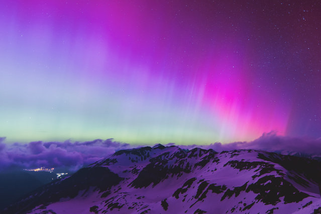 Northern lights or aurora borealis illuminate the night sky over Fusch an der Großglocknerstraße, near Zell am See, during a geomagnetic storm on May 11, 2024. The planet is experiencing its first “extreme” geomagnetic storm since 2003, a US agency said on Mai 10, 2024. (Photo by JFK/APA via AFP Photo) 