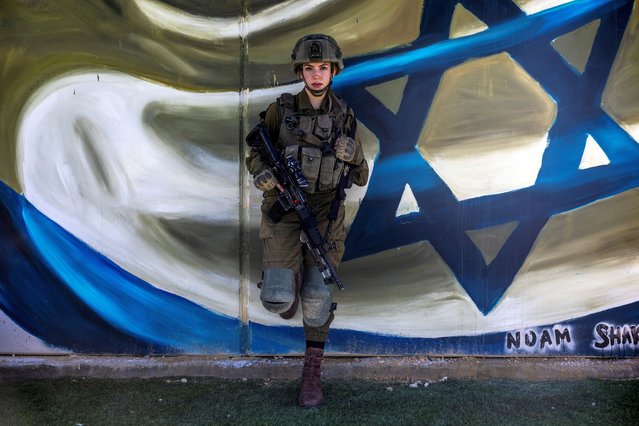 Shira, a Californian-born Israeli sharpshooter from the coed Bardelas Battalion, who served in the Gaza Strip amid the ongoing conflict in Gaza between Israel and Hamas, leans on a wall near Israel's border with Egypt in southern Israel, on February 21, 2024. (Photo by Ronen Zvulun/Reuters)