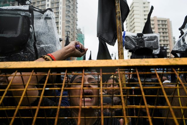 People participate in a silent protest organized by the leaders of Shiv Sena (Uddhav Balasaheb Thackeray), a regional party, condemning the alleged sexual assault of two minor girls in Badlapur school, at Shiv Sena Bhavan in Mumbai, India on August 24, 2024. (Photo by Hemanshi Kamani/Reuters)