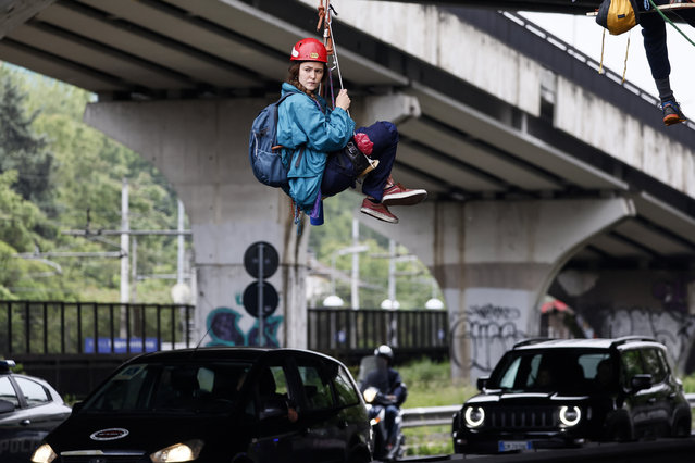 Environmental activists from Ultima Generazione block the city’s ring road during a protest in Rome, Italy on May 17, 2023. (Photo by Cecilia Fabiano/LaPresse/Rex Features/Shutterstock)