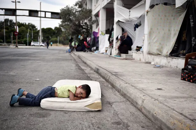 A refugee boy rests in the makeshift camp situated at the old Athens airport on June 13, 2016. (Photo by Louisa Gouliamaki/AFP Photo)