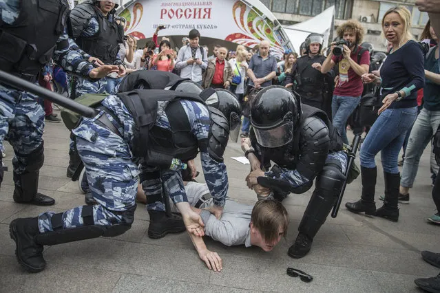 Police detain a protester In Moscow, Russia, Monday, June 12, 2017. Demonstrators in Monday's opposition protests across Russia say they are fed up with endemic corruption among officials. The protest gatherings in cities from Far East Pacific ports to St. Petersburg were spearheaded by Alexei Navalny, the anti-corruption campaigner who has become the Kremlin's most visible opponent. (Photo by Evgeny Feldman/Pool Photo via AP Photo)