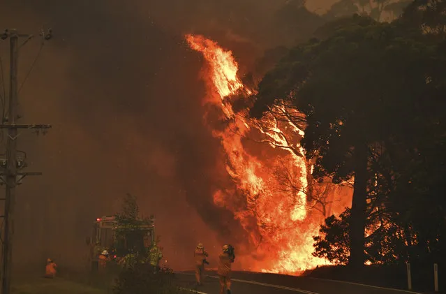 A fire truck is seen during a bushfire near Bilpin, 90 kilometers (56 miles) northwest of Sydney, Thursday, December 19, 2019. Australia's most populous state of New South Wales declared a seven-day state of emergency Thursday as oppressive conditions fanned around 100 wildfires. (Photo by Mick Tsikas/AAP Images via AP Photo)