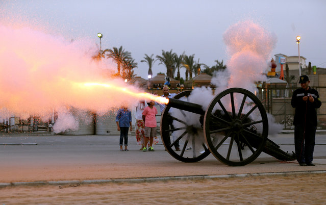 An Egyptian family watches as a cannon fires to announce the time to break the fast during the Ramadan in Cairo, Egypt June 13, 2016. (Photo by Mohamed Abd El Ghany/Reuters)