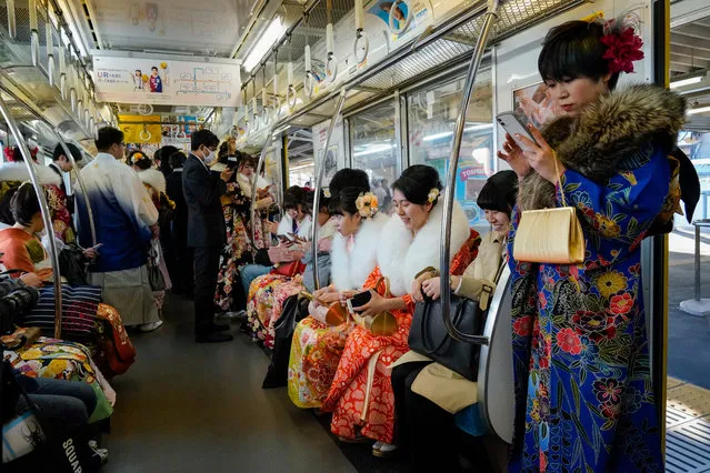 Young Japanese women dressed in colorful kimonos sit inside a train car after attending a ceremony marking the Coming of Age Day at Toshimaen Amusement Park in Tokyo, Japan, 13 January 2020. (Photo by Christopher Jue/EPA/EFE)