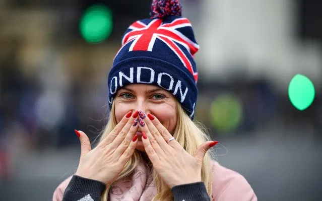 A tourist poses for a photograph outside the Houses of Parliament on January 30, 2020 in London, United Kingdom. At 11.00pm on Friday 31st January the UK and Northern Ireland will exit the European Union 188 weeks after the referendum on June 23rd 2016. (Photo by Jeff J. Mitchell/Getty Images)
