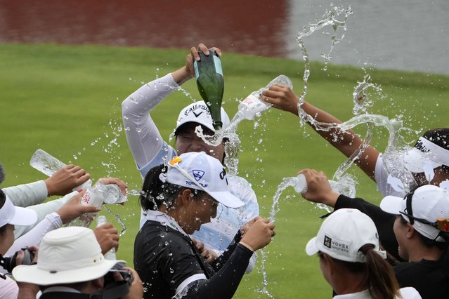 Fellow golfers sprinkle water on Ruoning Yin of China after she wins the final round of the LPGA Shanghai at China's Shanghai Qizhong Garden Golf Club, Sunday, October 13, 2024. (Photo by Achmad Ibrahim/AP Photo)