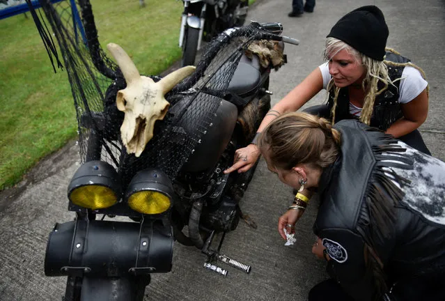 Participants prepare their motorbikes for a ride out at the women-only Petrolettes motorcycle festival in Neuhardenberg near Berlin, Germany on July 29, 2017. (Photo by Stefanie Loos/Reuters)