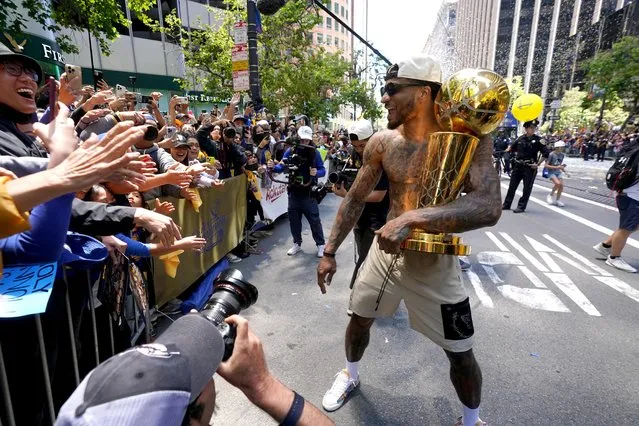 Golden State Warriors guard Gary Payton II holds the Larry O'Brien Championship Trophy next to fans during the Golden State Warriors Victory Parade on June 20, 2022 in San Francisco, California. The Golden State Warriors beat the Boston Celtics 4-2 to win the 2022 NBA Finals. (Photo by Cary Edmondson/USA TODAY Sports)