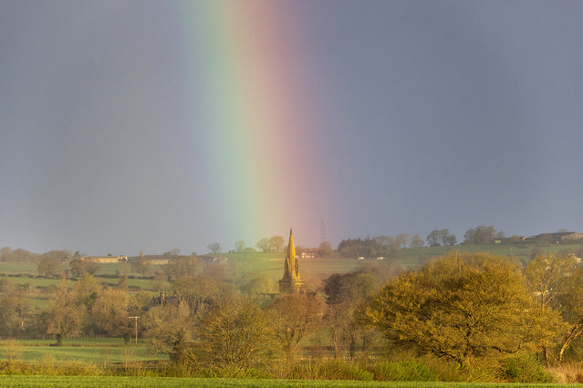 A rainbow forms over the spire of St Barnabas church in the village of Weeton, Yorkshire on April 7, 2024, as much of the UK feels the effect of Storm Kathleen. (Photo by Andrew McCaren/London News Pictures)